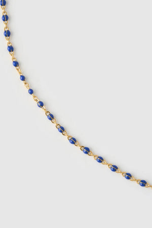 Peggy Necklace Blueberry by Arms of Eve, a dainty gold chain with blueberry enamel beads, perfect for summer layering and open-back looks.