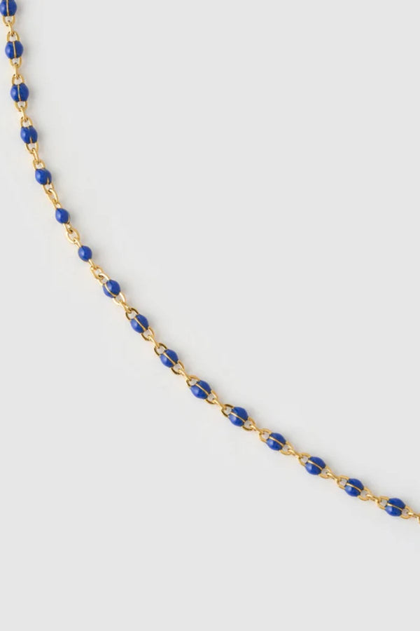 Peggy Necklace Blueberry by Arms of Eve, a dainty gold chain with blueberry enamel beads, perfect for summer layering and open-back looks.