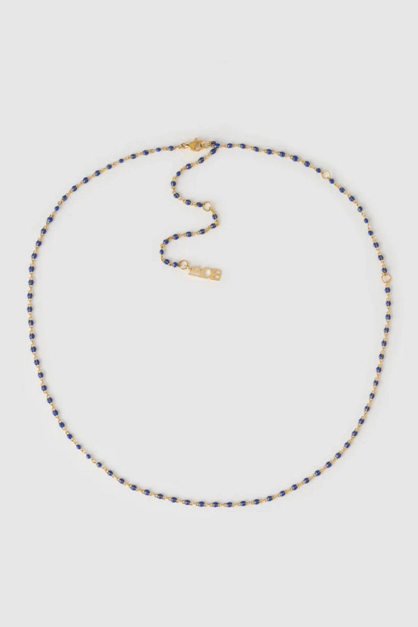 Peggy Necklace Blueberry by Arms of Eve, a dainty gold chain with blueberry enamel beads, perfect for summer layering and open-back looks.