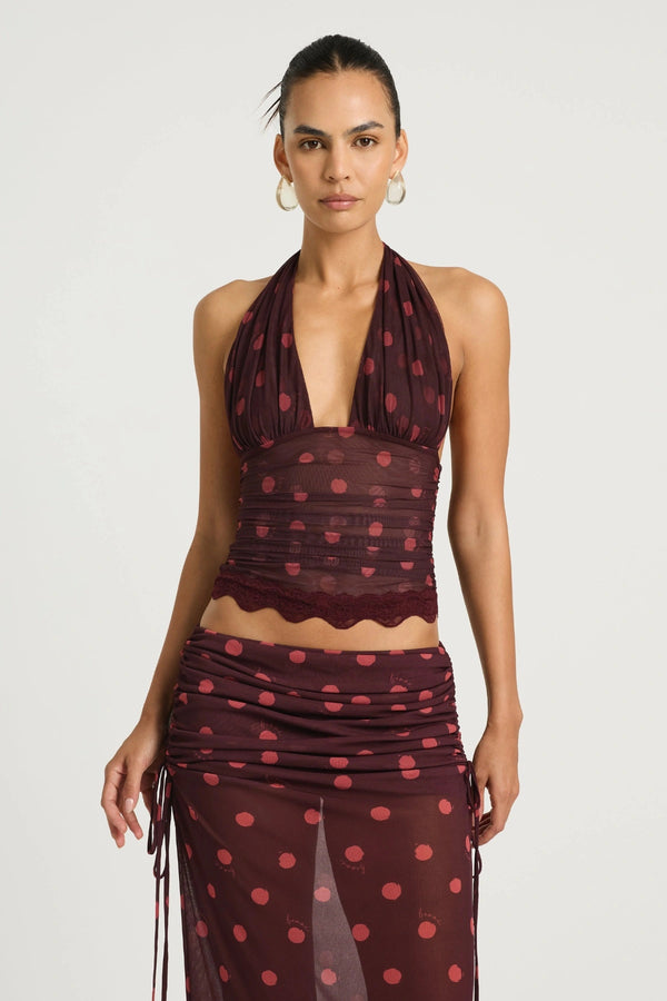 Penelope Top Plum Spot by Benni, a plunge halter lace-trim style with adjustable ties and stretch mesh lining for elevated day-to-night dressing.
