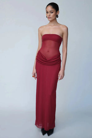 Petra Maxi Dress Wine by Benni, a strapless bandeau dress with a panelled waist, sheer mesh torso, and signature cowl drape for modern elegance. Perfect for formal events