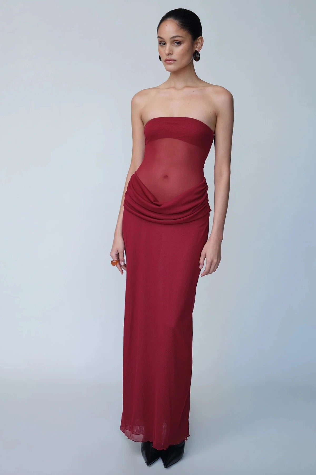 Petra Maxi Dress Wine by Benni, a strapless bandeau dress with a panelled waist, sheer mesh torso, and signature cowl drape for modern elegance. Perfect for formal events