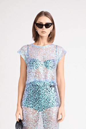 Delphine Top by Pfeiffer, lightweight sequin knit, relaxed fit with keyhole back neck detail. Perfect for layering over bras or swimwear. Spot clean only, 100% polyester.