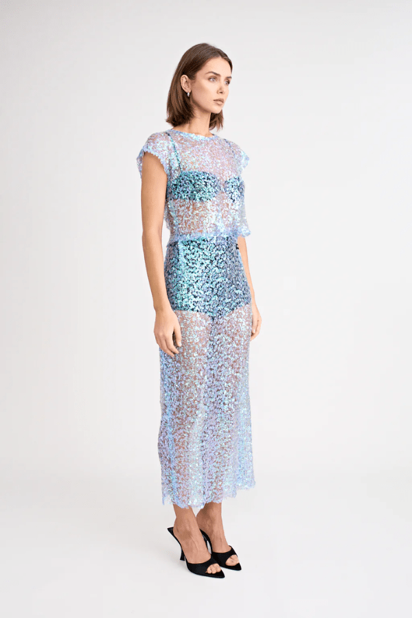 Delphine Top by Pfeiffer, lightweight sequin knit, relaxed fit with keyhole back neck detail. Perfect for layering over bras or swimwear. Spot clean only, 100% polyester.








