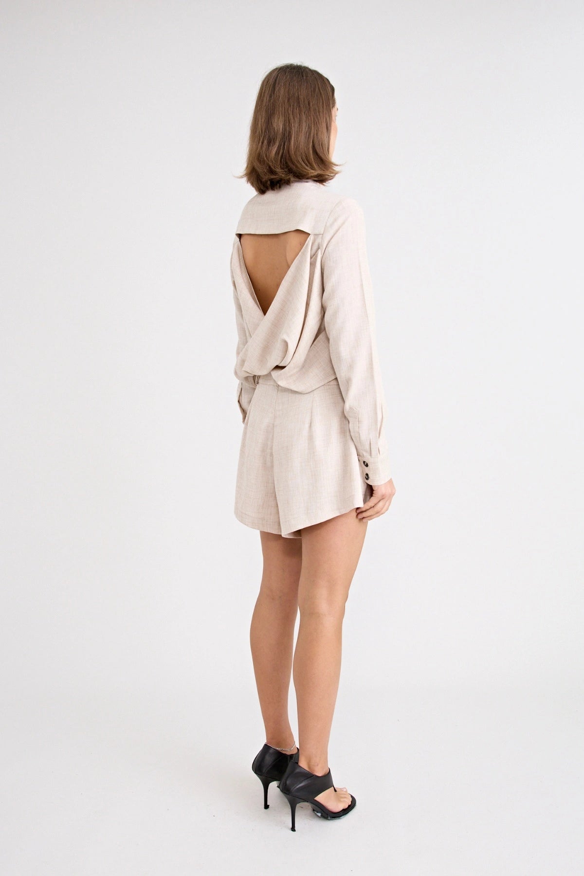 Pino Twist Shirt by Pfeiffer — a lightweight natural button-up with a subtle twist front and relaxed drape, perfect for effortless styling.
