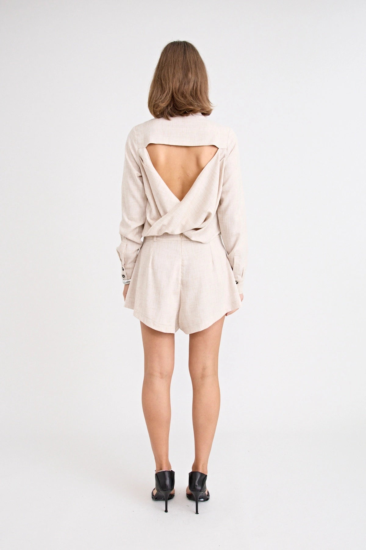 Pino Twist Shirt by Pfeiffer — a lightweight natural button-up with a subtle twist front and relaxed drape, perfect for effortless styling.
