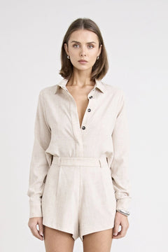 Pino Twist Shirt by Pfeiffer — a lightweight natural button-up with a subtle twist front and relaxed drape, perfect for effortless styling.
