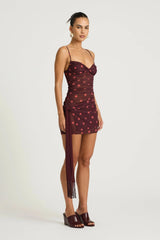 Piper Twist Dress Plum Spot by Benni, a twisted cami mini with draped overlay and tassel waist tie for elevated day-to-night dressing.
