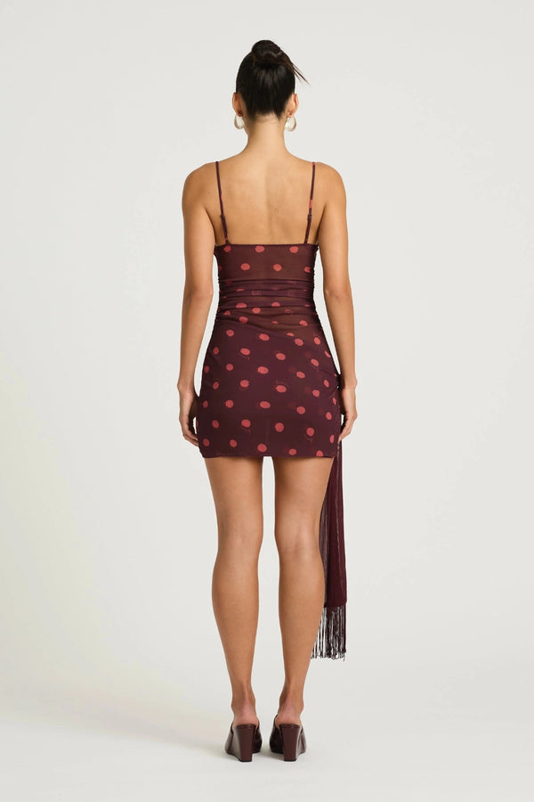 Piper Twist Dress Plum Spot by Benni, a twisted cami mini with draped overlay and tassel waist tie for elevated day-to-night dressing.
