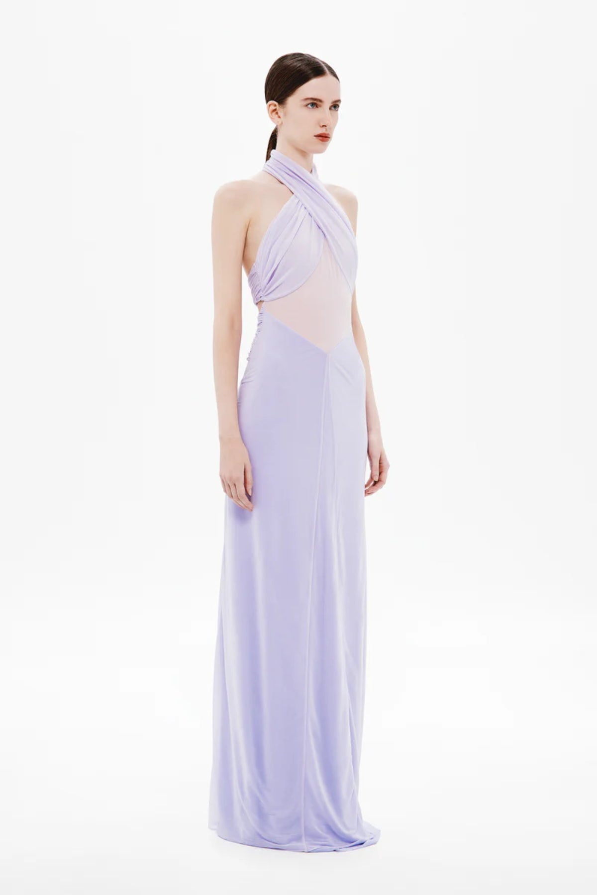 Pippa Braid Dress by Misha, a halter maxi in fluid jersey with crossover bodice, sheer midsection, and sculptural braided back for timeless elegance.