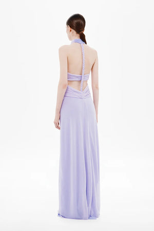 Pippa Braid Dress by Misha, a halter maxi in fluid jersey with crossover bodice, sheer midsection, and sculptural braided back for timeless elegance.