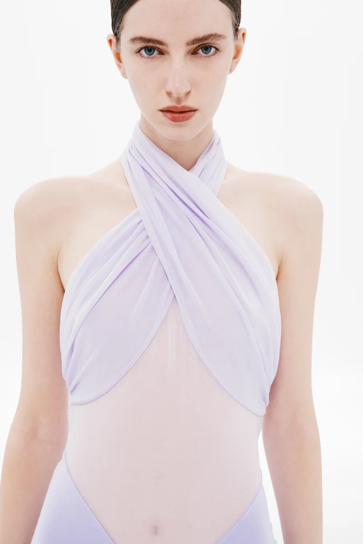 Pippa Braid Dress by Misha, a halter maxi in fluid jersey with crossover bodice, sheer midsection, and sculptural braided back for timeless elegance.