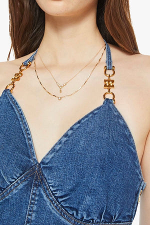 Platform Heel Over The Top by MOTHER, denim jumpsuit with halter neckline and wide leg fit. Perfect for statement outfits or standout looks.