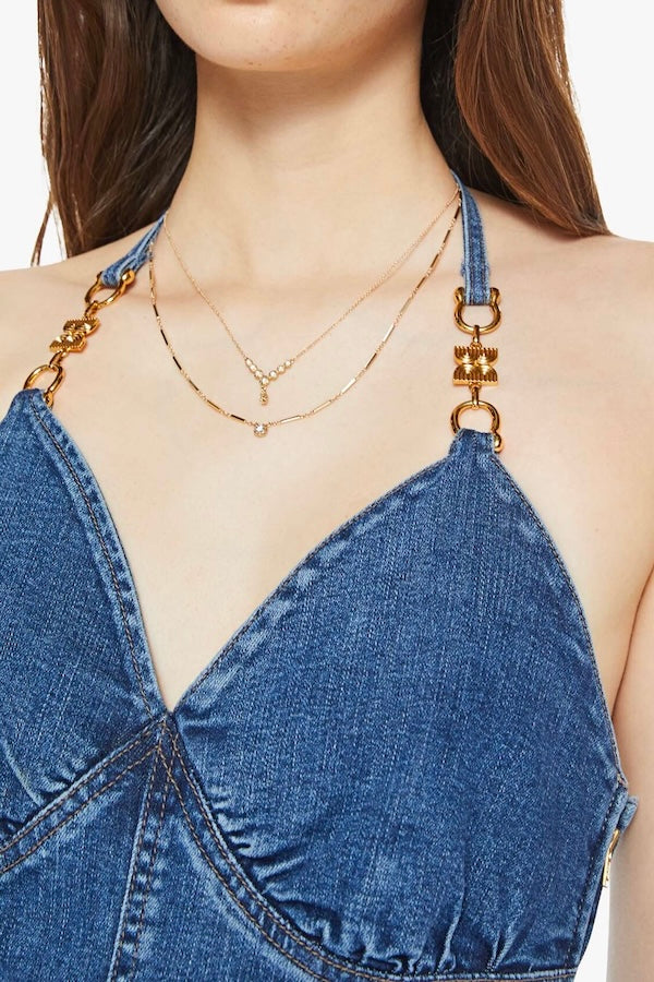 Platform Heel Over The Top by MOTHER, denim jumpsuit with halter neckline and wide leg fit. Perfect for statement outfits or standout looks.