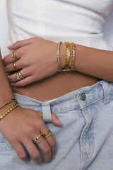 Quinn Gold Cuff Stone by Arms of Eve, a 14k gold PVD open cuff bracelet with radiant zircon stone detailing.