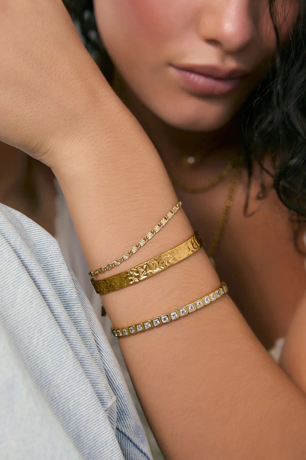 Quinn Gold Cuff Stone by Arms of Eve, a 14k gold PVD open cuff bracelet with radiant zircon stone detailing.
