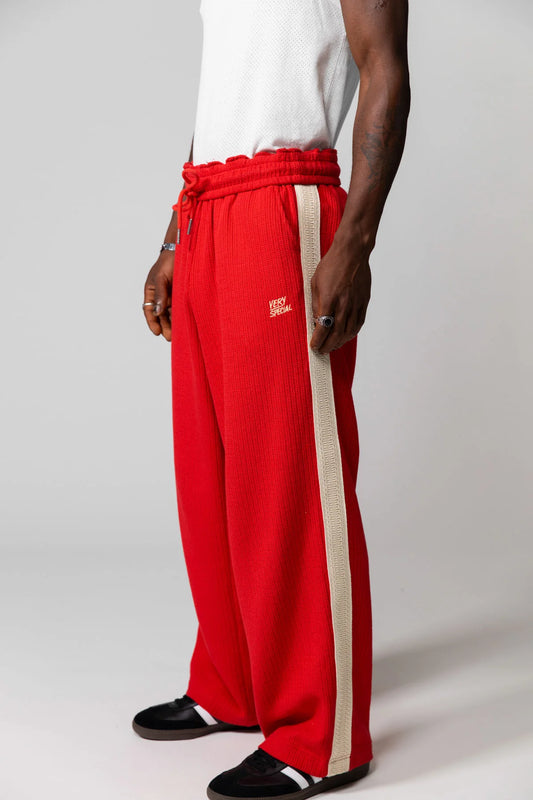 Red Knitted Baggy Pants by Something Very Special, featuring stripe jacquard and tonal embroidery. Unisex fit for everyday comfort.