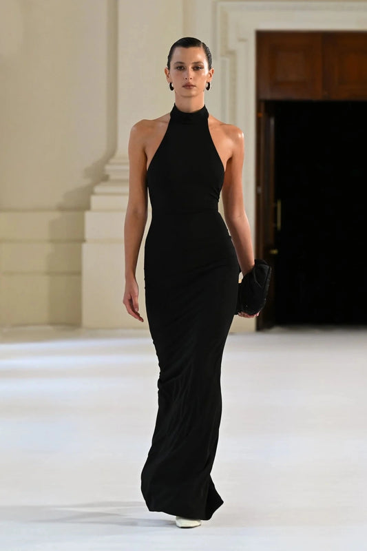 Rhi Gown in Black by Effie Kats, floor-length stretch crepe gown with open back and high neckline. Perfect for formal events and special evenings.