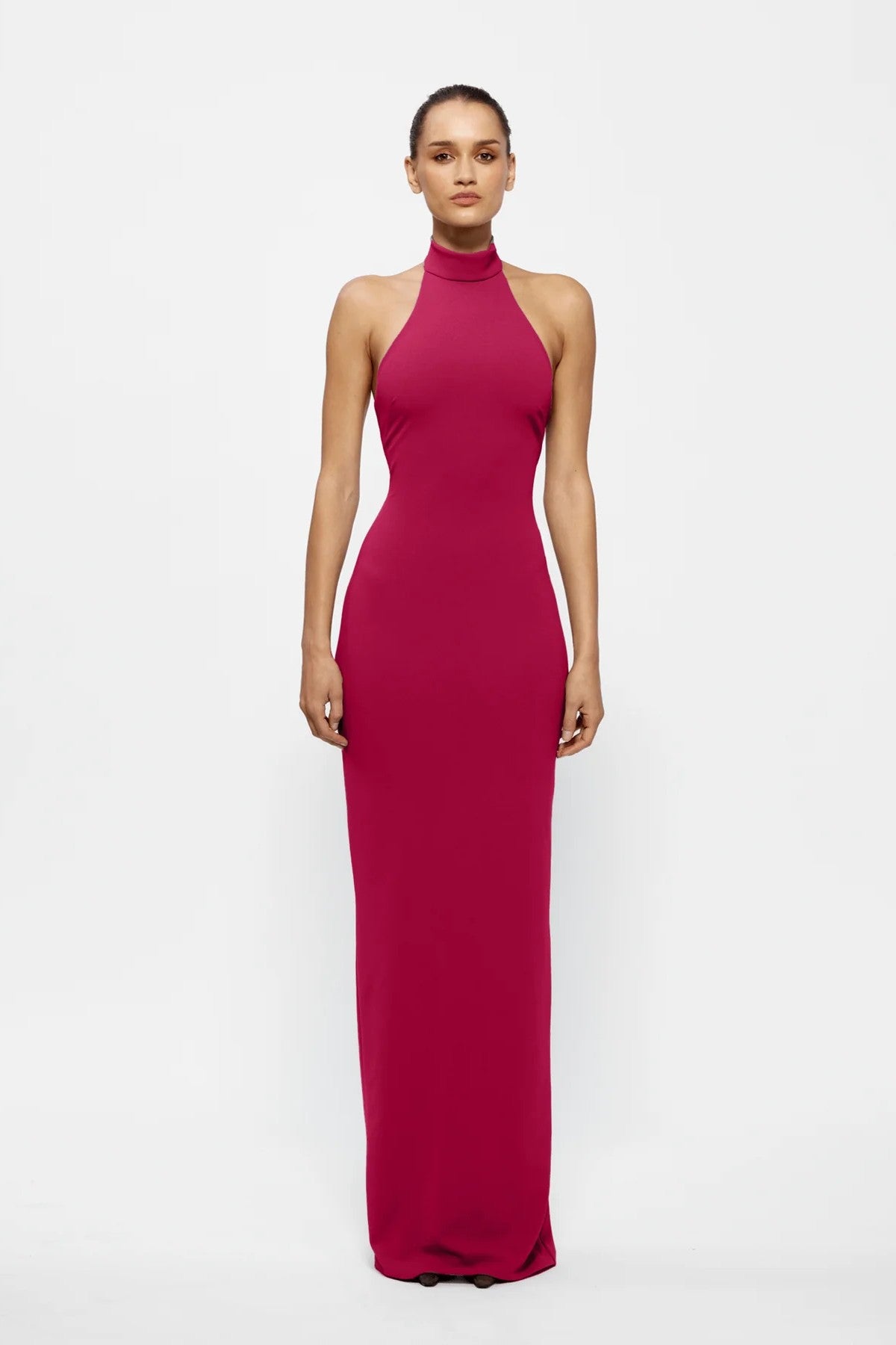 Rhi Gown in Raspberry by Effie Kats, a sleek stretch crepe gown featuring a high neckline, open back, and floor-length hemline for timeless elegance.