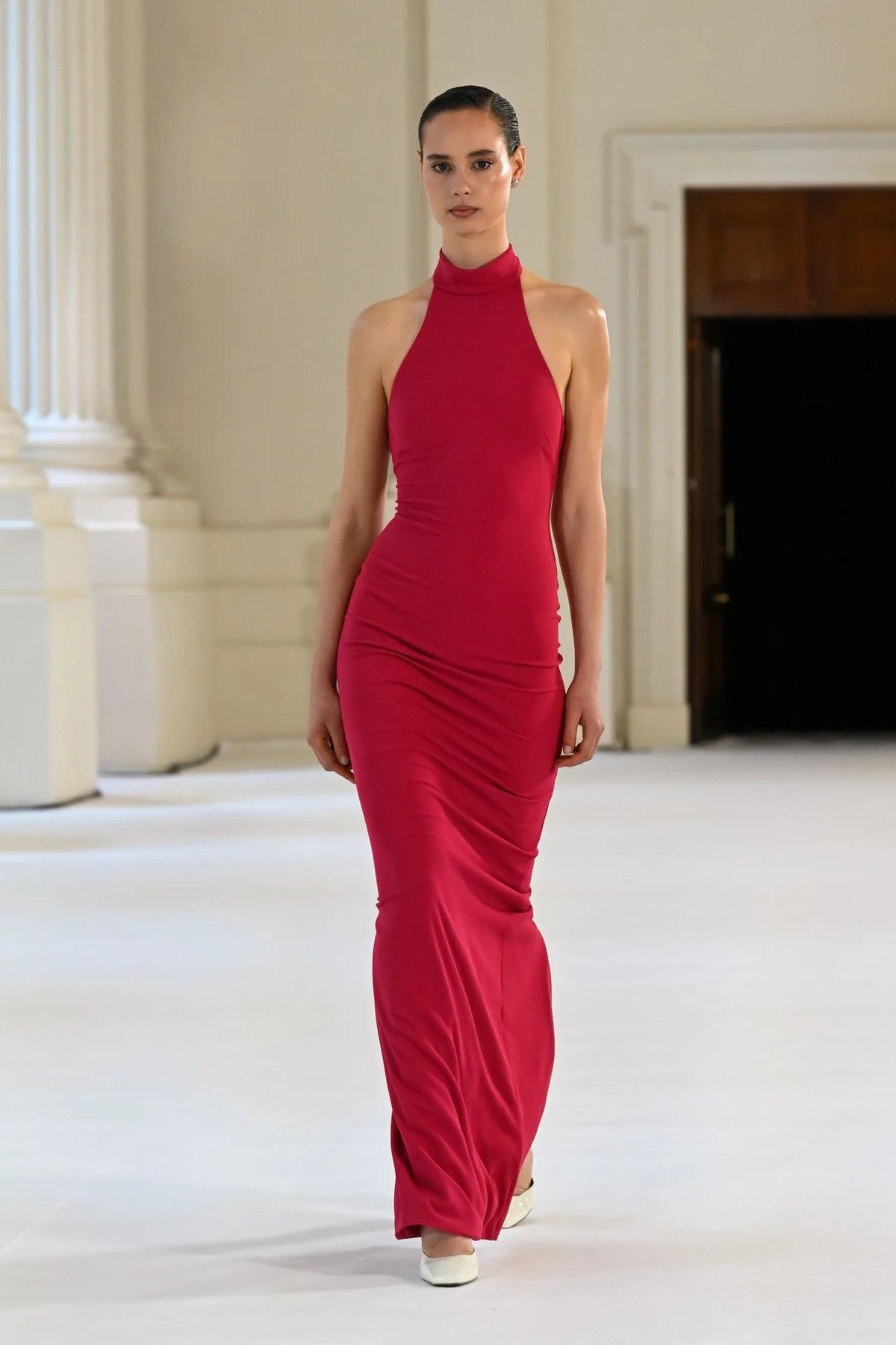 Rhi Gown in Raspberry by Effie Kats, a sleek stretch crepe gown featuring a high neckline, open back, and floor-length hemline for timeless elegance.