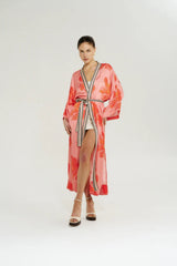 Robe in Peach Petals by Summi Summi, a flowing floral robe with wide sleeves, contrast trim, and an adjustable waist tie.
