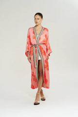 Robe in Peach Petals by Summi Summi, a flowing floral robe with wide sleeves, contrast trim, and an adjustable waist tie.