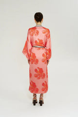 Robe in Peach Petals by Summi Summi, a flowing floral robe with wide sleeves, contrast trim, and an adjustable waist tie.