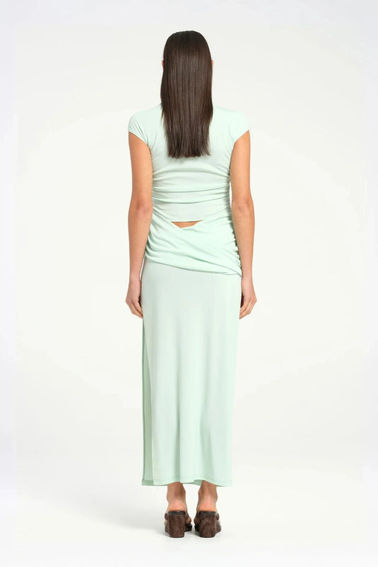 Royce Maxi Dress Aqua by Bec + Bridge, a sleek silhouette with a twisted waist, cowl detail, and side split, perfect for modern evening dressing.