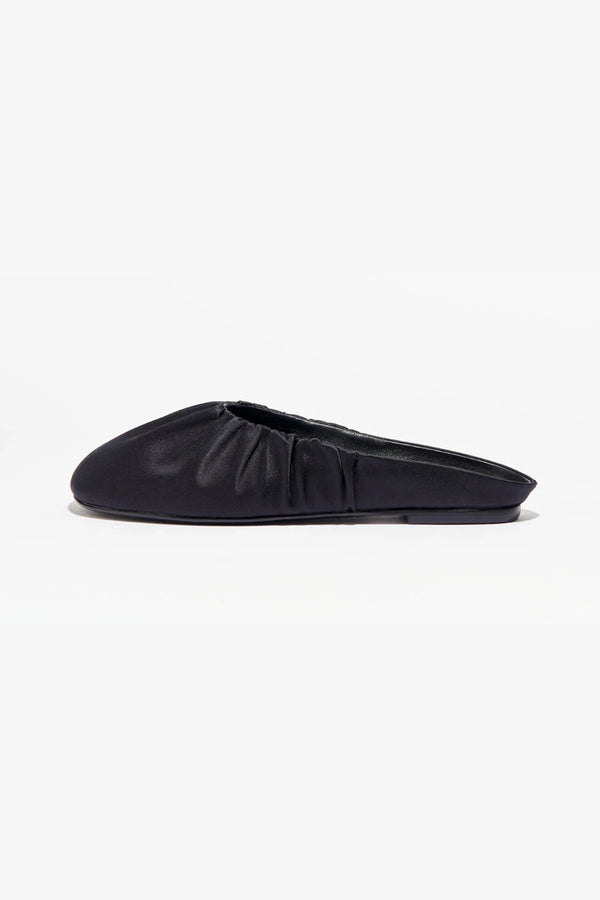 Rue in Black Satin by Alias Mae, a mule-style ballet flat with ruched topline and leather lining.