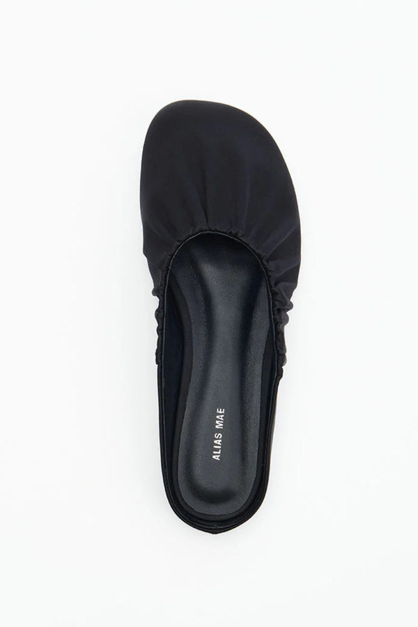 Rue in Black Satin by Alias Mae, a mule-style ballet flat with ruched topline and leather lining.