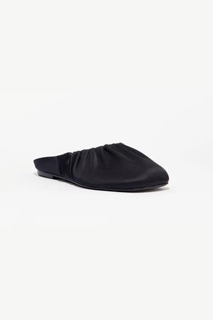 Rue in Black Satin by Alias Mae, a mule-style ballet flat with ruched topline and leather lining.
