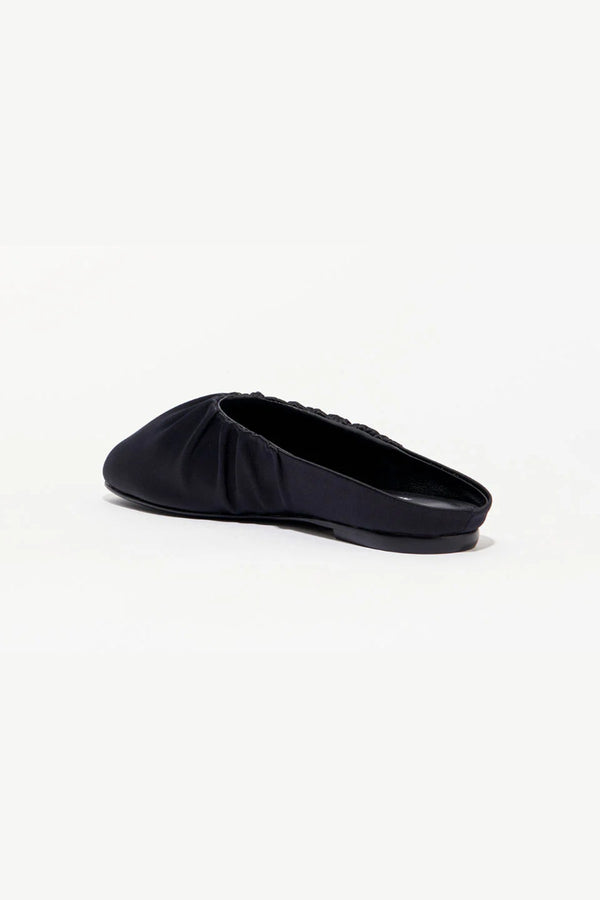 Rue in Black Satin by Alias Mae, a mule-style ballet flat with ruched topline and leather lining.