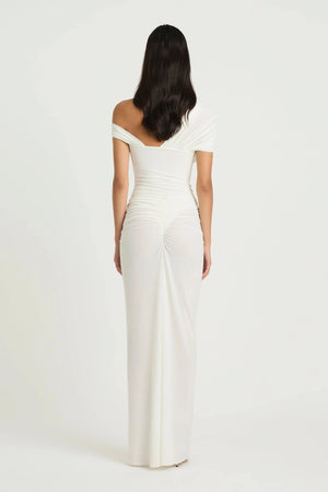 Rumi Maxi Dress by Benni — an asymmetric stretch jersey dress with a gathered skirt and cascading split, perfect for elevated evenings.