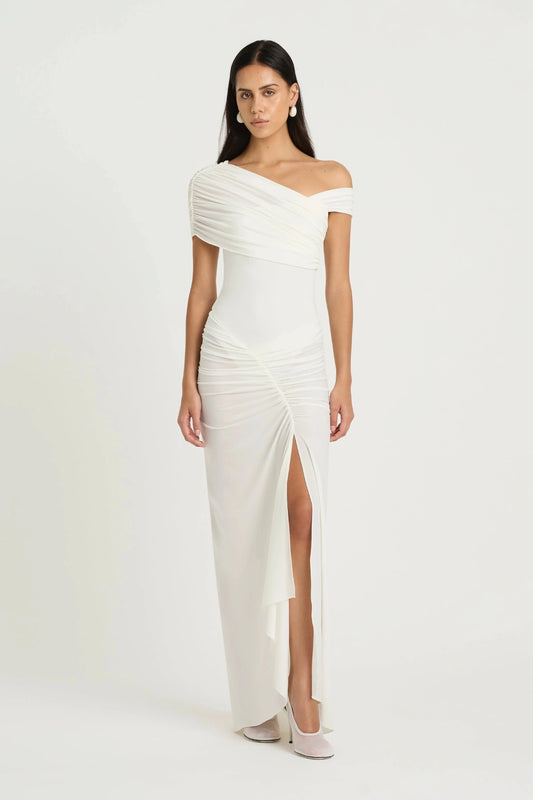 Rumi Maxi Dress by Benni — an asymmetric stretch jersey dress with a gathered skirt and cascading split, perfect for elevated evenings.