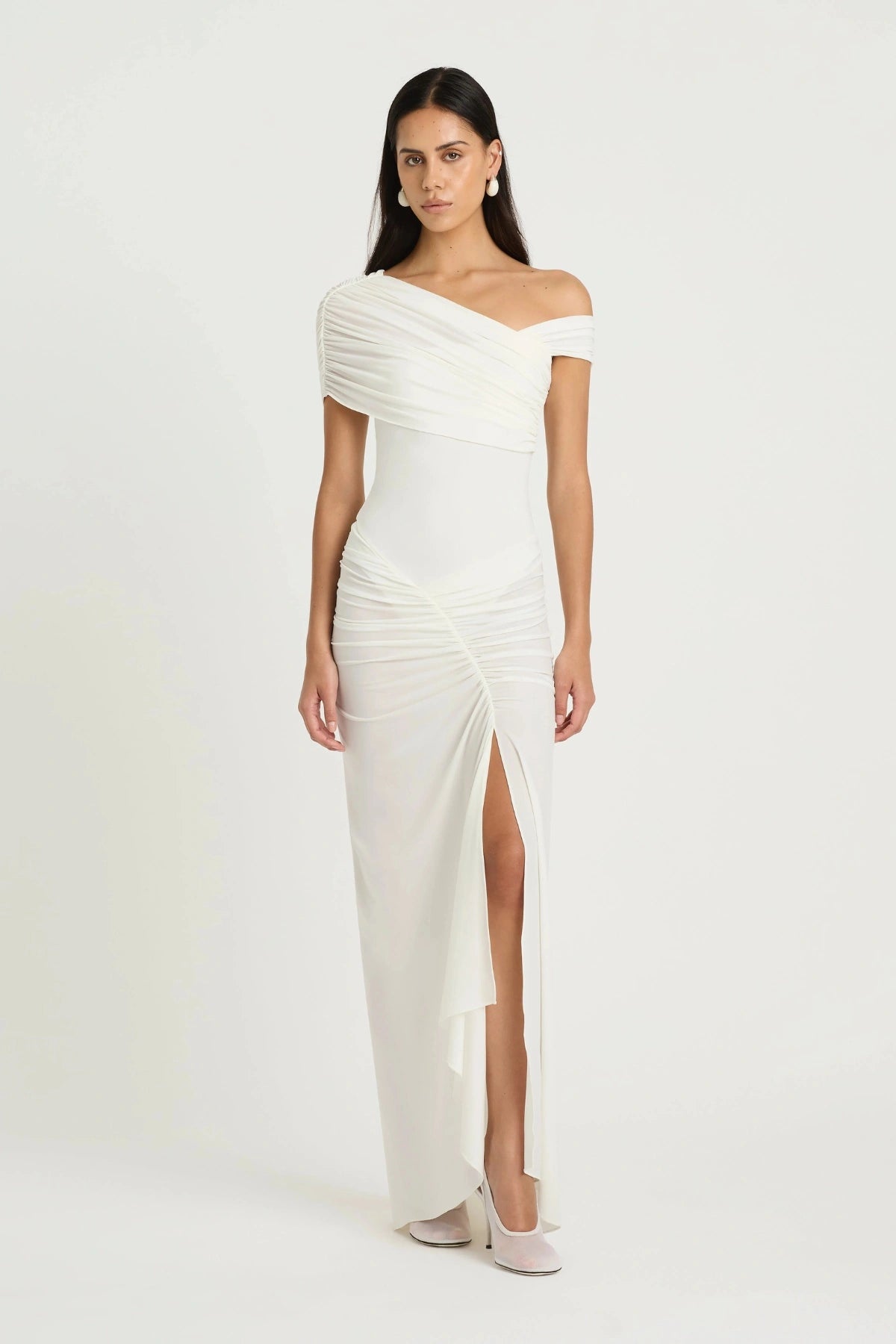 Rumi Maxi Dress by Benni — an asymmetric stretch jersey dress with a gathered skirt and cascading split, perfect for elevated evenings.