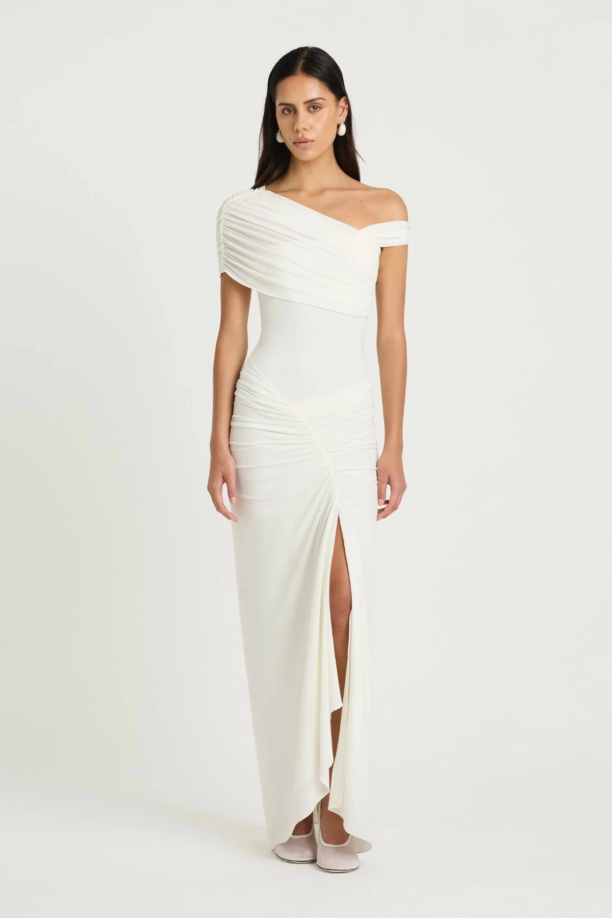 Rumi Maxi Dress by Benni — an asymmetric stretch jersey dress with a gathered skirt and cascading split, perfect for elevated evenings.