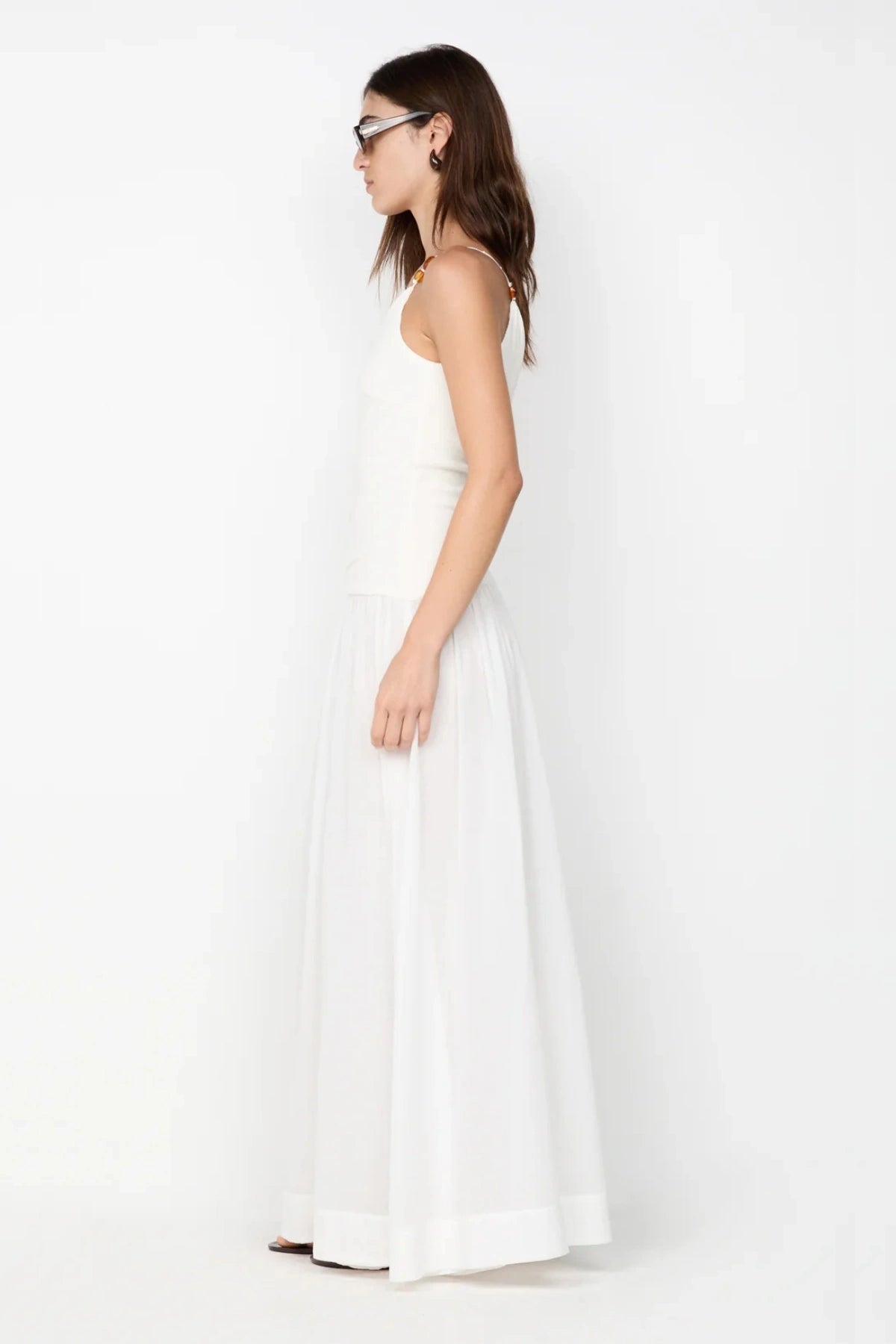 Sabrine Asym Maxi Dress by Bec + Bridge, ivory maxi with amber bead strap and ribbed bodice. Perfect for bridal or summer escapes.