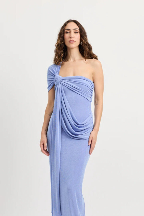 Sakura Dress by Tojhà – a cornflower blue slinky jersey maxi with asymmetric draping and a soft shawl detail, perfect for elegant evening styling.