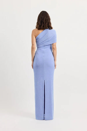 Sakura Dress by Tojhà – a cornflower blue slinky jersey maxi with asymmetric draping and a soft shawl detail, perfect for elegant evening styling.