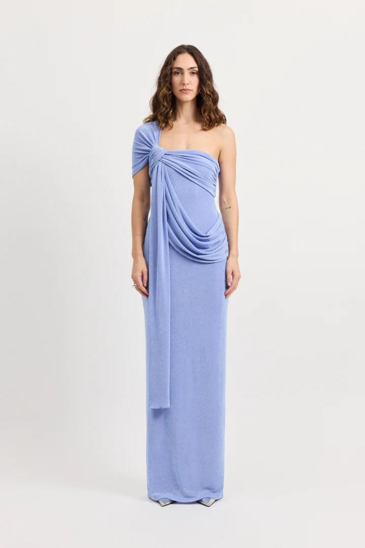 Sakura Dress by Tojhà – a cornflower blue slinky jersey maxi with asymmetric draping and a soft shawl detail, perfect for elegant evening styling.