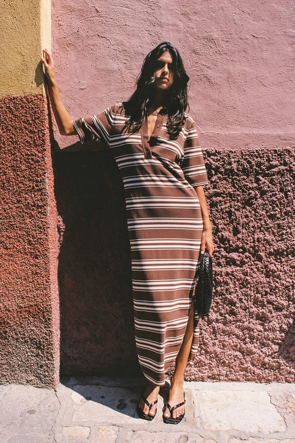Santiago Polo Dress in Ombre Stripe Macro Carob by Faithfull the Brand, a relaxed knit midi with collar neckline, side splits, and chocolate stripe finish.