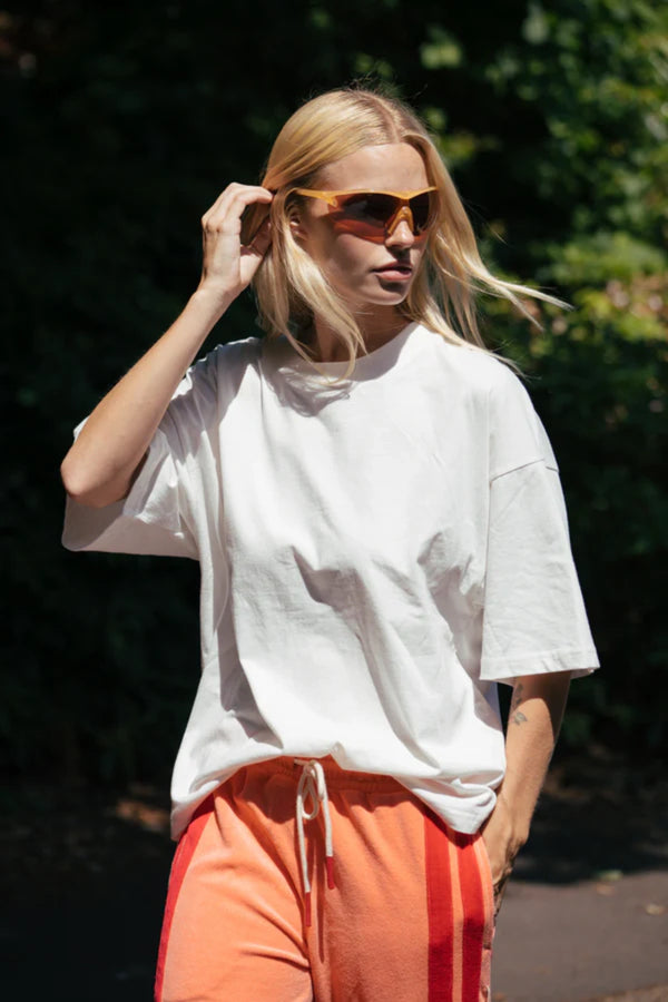 Santorini Oversized Tee in Warm White by Araminta James, relaxed cotton tee with crew neckline and graphic print, perfect for effortless everyday styling with wide-leg pants.