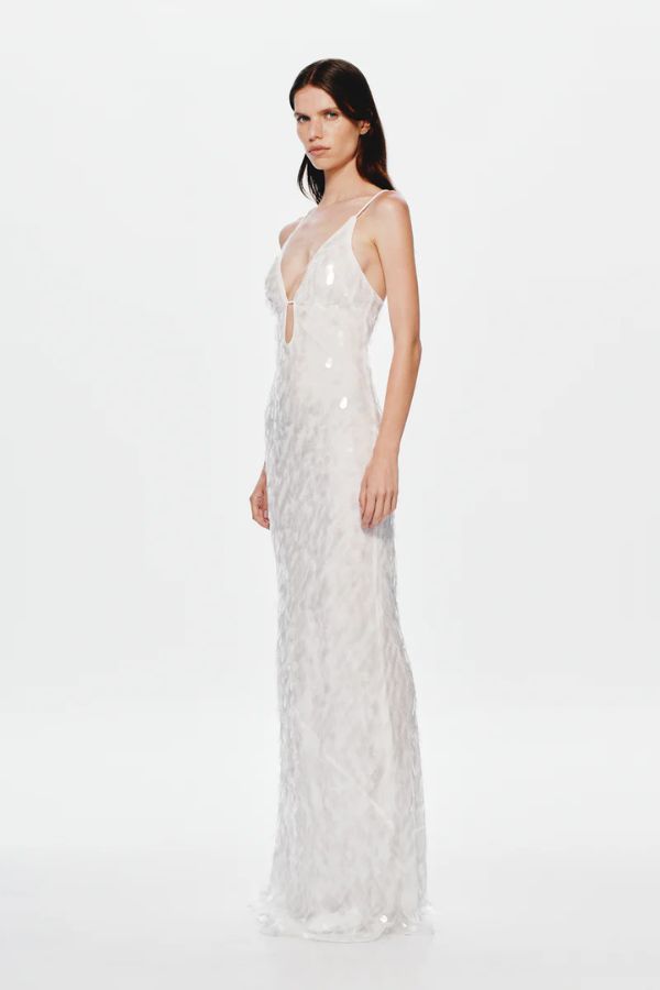 Sapphire Sequin Maxi Dress in Ivory by Misha, stunning body-con silhouette with plunging V-neckline, bust cut-out, and voluminous hem, perfect for making a dramatic entrance at evening events.