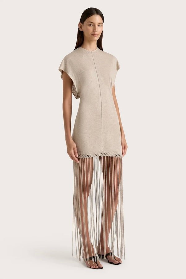 Ines Fringe Dress Oatmeal by Faithfull the Brand – Sheer linen mini with macrame hem, fringe skirt, and batwing sleeves.