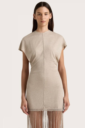 Ines Fringe Dress Oatmeal by Faithfull the Brand – Sheer linen mini with macrame hem, fringe skirt, and batwing sleeves.
