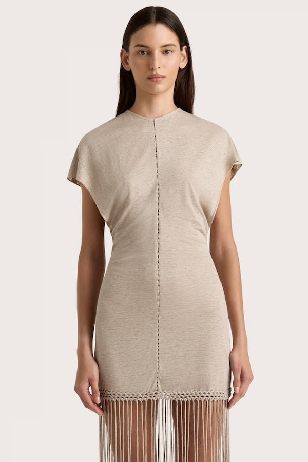 Ines Fringe Dress Oatmeal by Faithfull the Brand – Sheer linen mini with macrame hem, fringe skirt, and batwing sleeves.