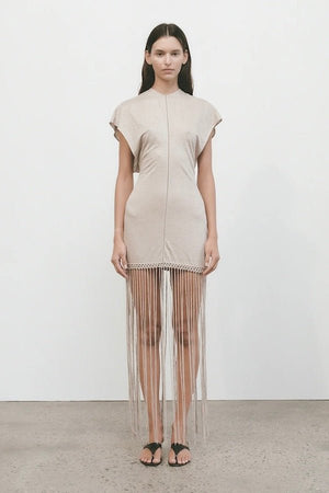Ines Fringe Dress Oatmeal by Faithfull the Brand – Sheer linen mini with macrame hem, fringe skirt, and batwing sleeves.