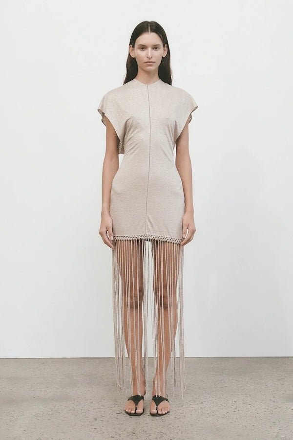 Ines Fringe Dress Oatmeal by Faithfull the Brand – Sheer linen mini with macrame hem, fringe skirt, and batwing sleeves.