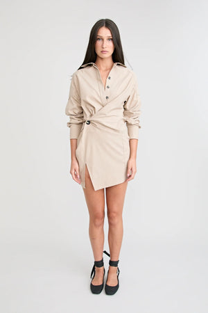 Shop the Zena Twist Dress Beige by Pfeiffer at Girls with Gems. A pinstripe shirt dress with signature twists, waist tucks.