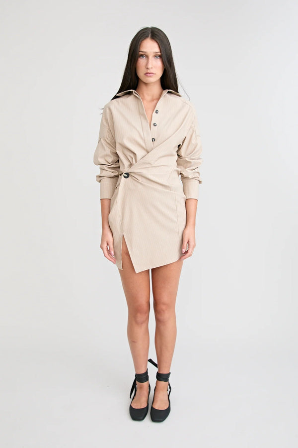 Shop the Zena Twist Dress Beige by Pfeiffer at Girls with Gems. A pinstripe shirt dress with signature twists, waist tucks.